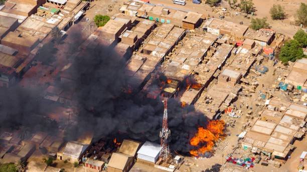 Massive smoke rises from an explosion in Sudan, highlighting the escalating human rights violations and displacement crisis in the region
